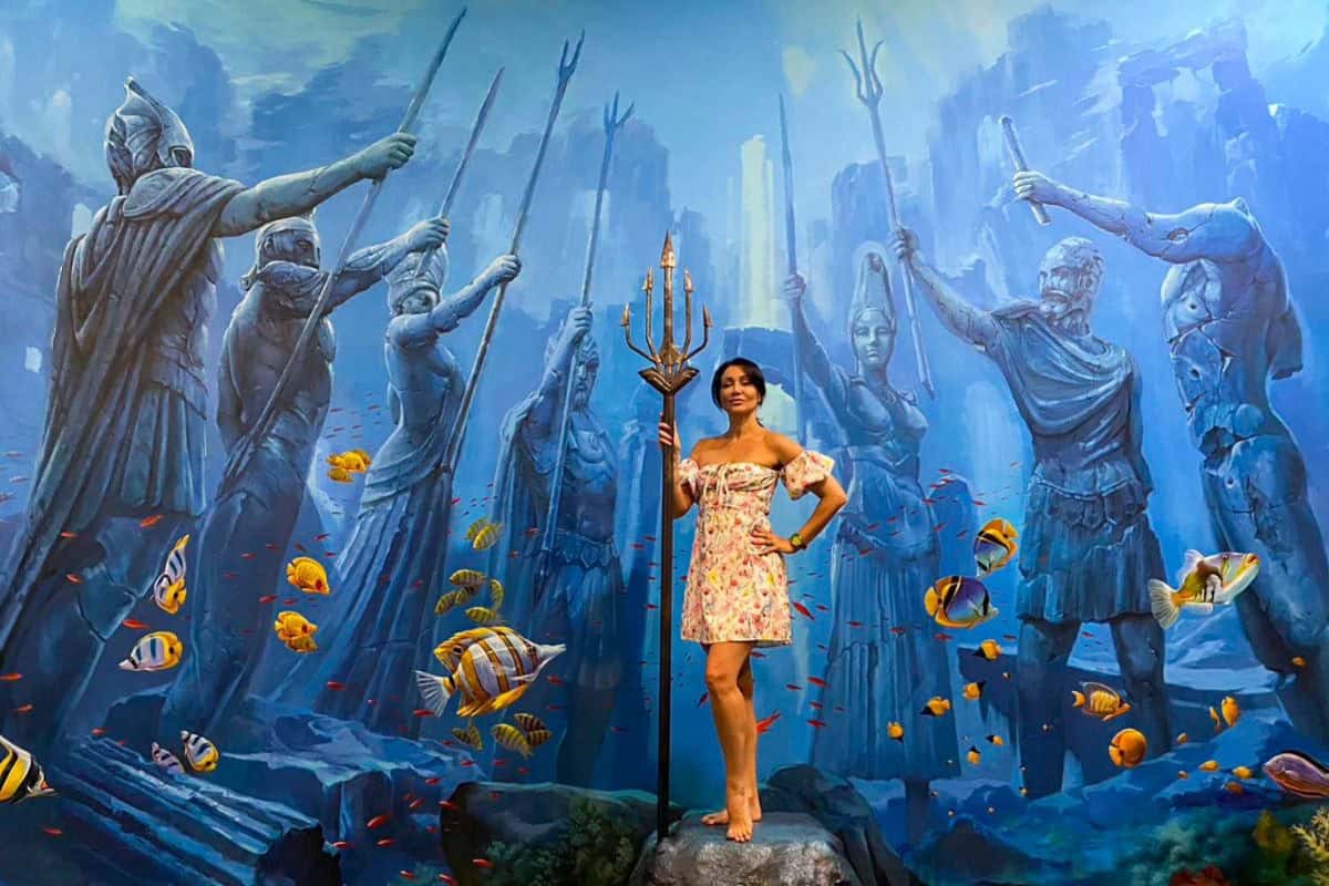 woman posing in front of painting at art in paradise pattaya