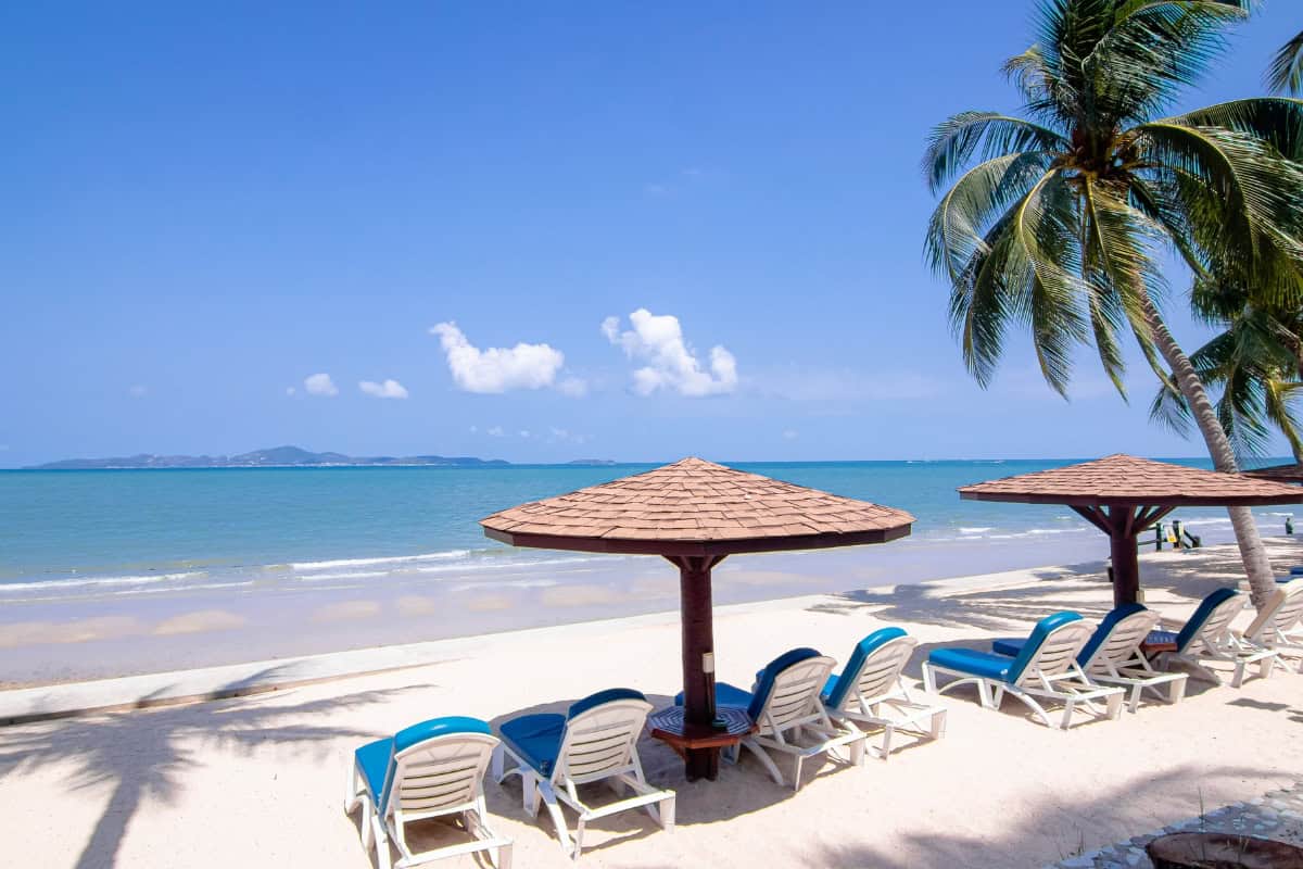 sun loungers with umbrellas on our private beach with stunning ocean views