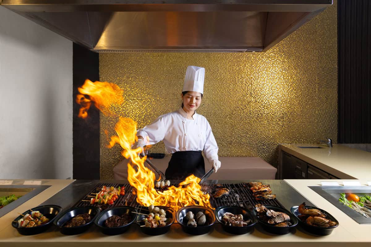 chef preparing international food in pattaya in an open kitchen