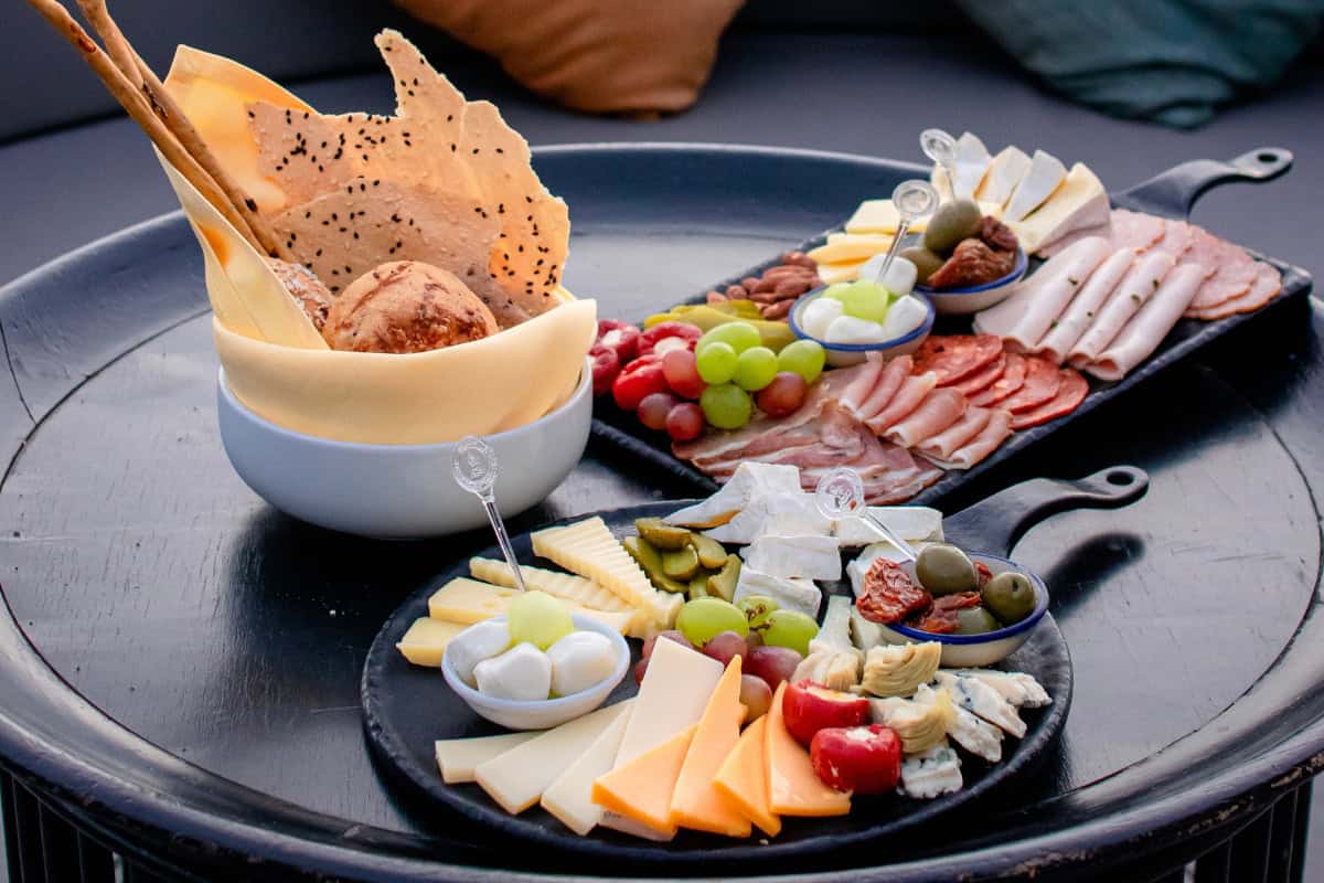 various cheese board ingredients presented on a black tray