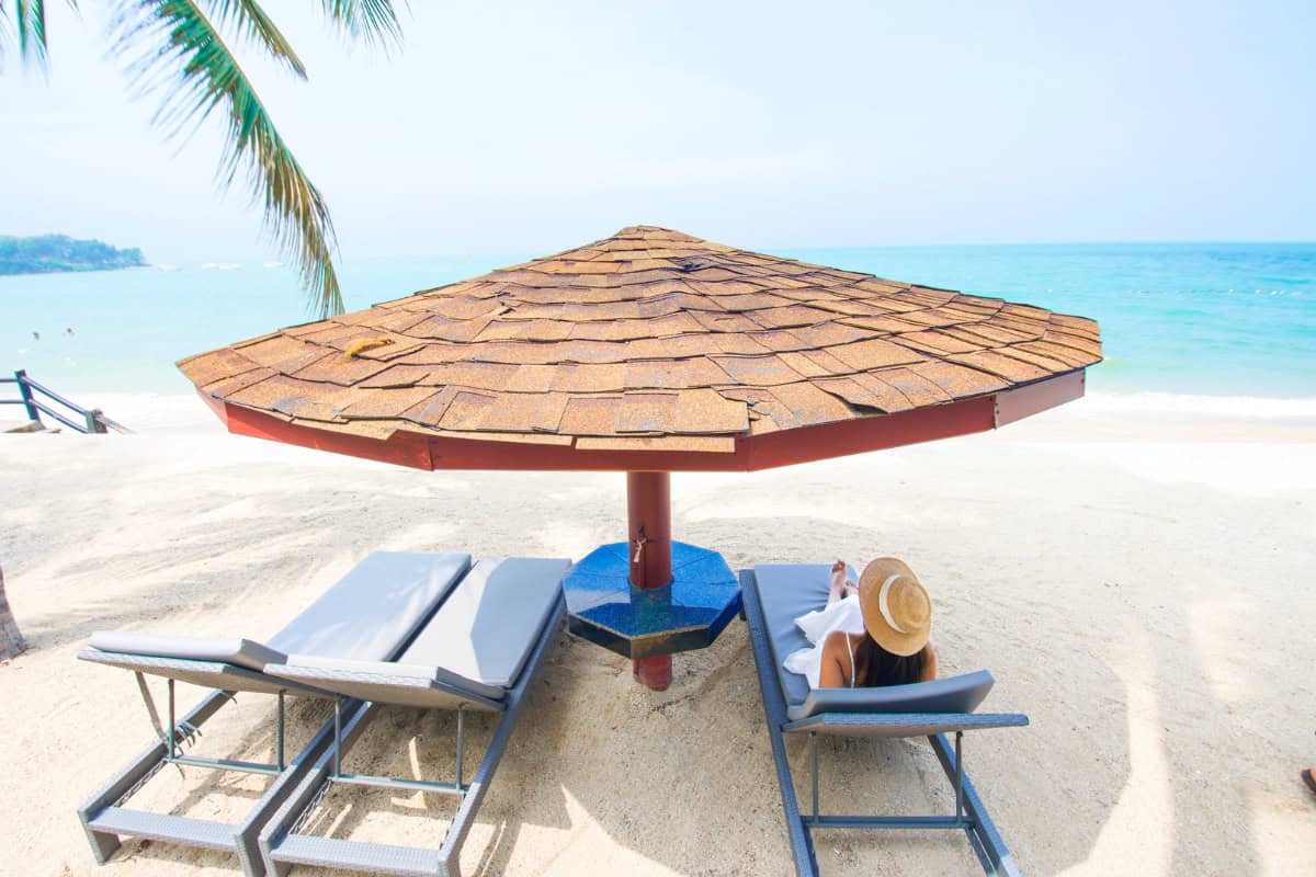 guest sitting on lounger on private beach writing a pattaya hotel review