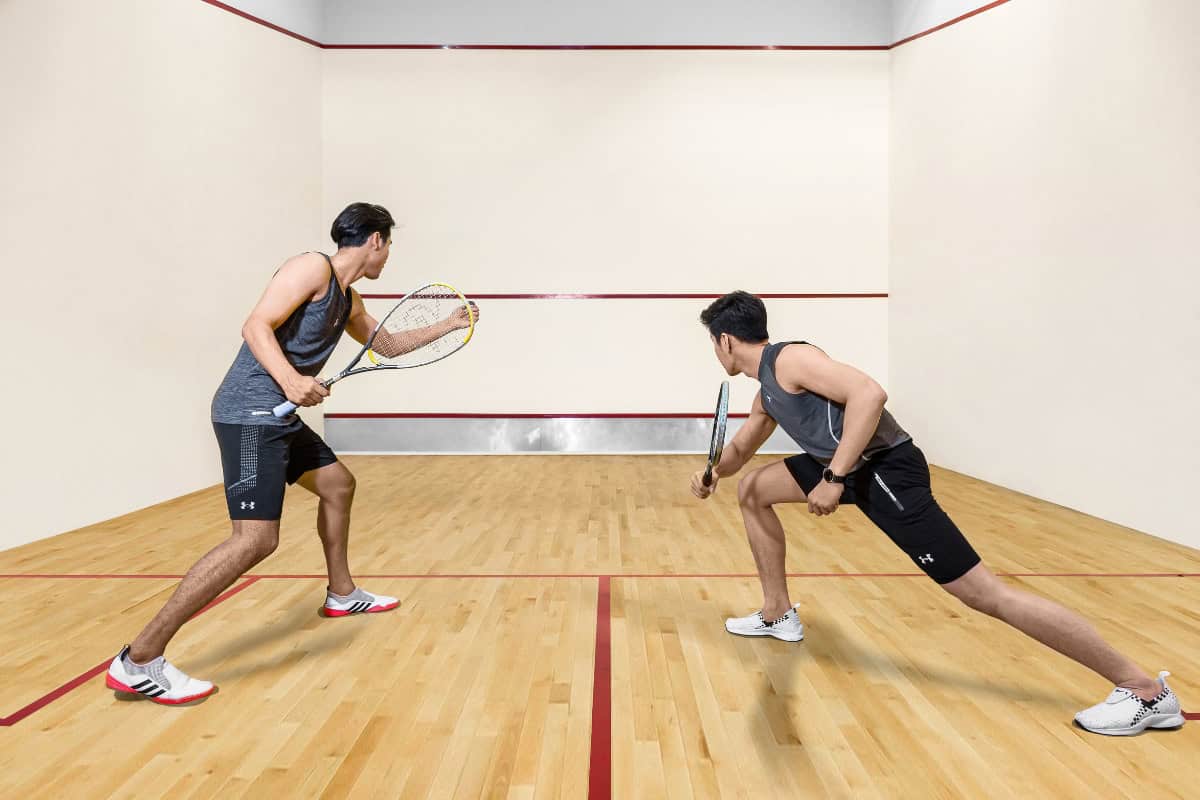 men get ready to start a game at a squash court in pattaya