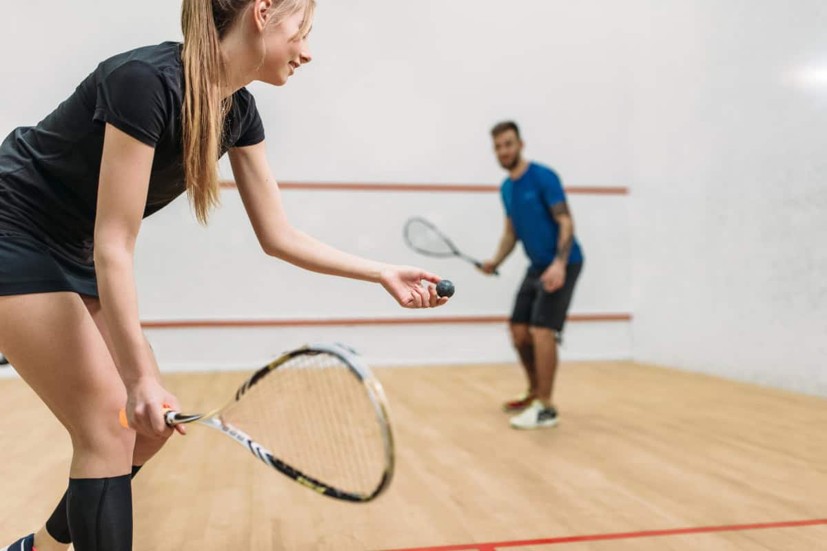 woman explaining what is squash at a court in pattaya